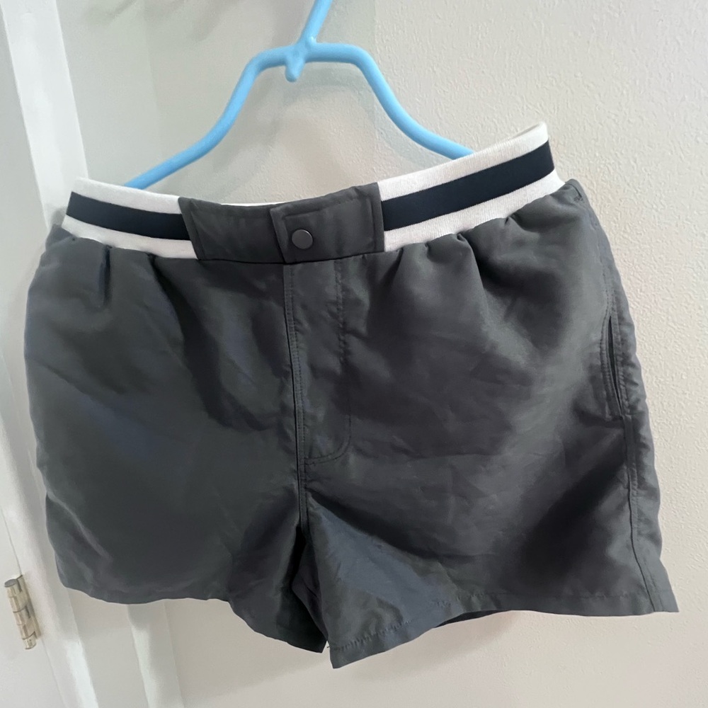 Gray swim trunks with white elastic waistband.